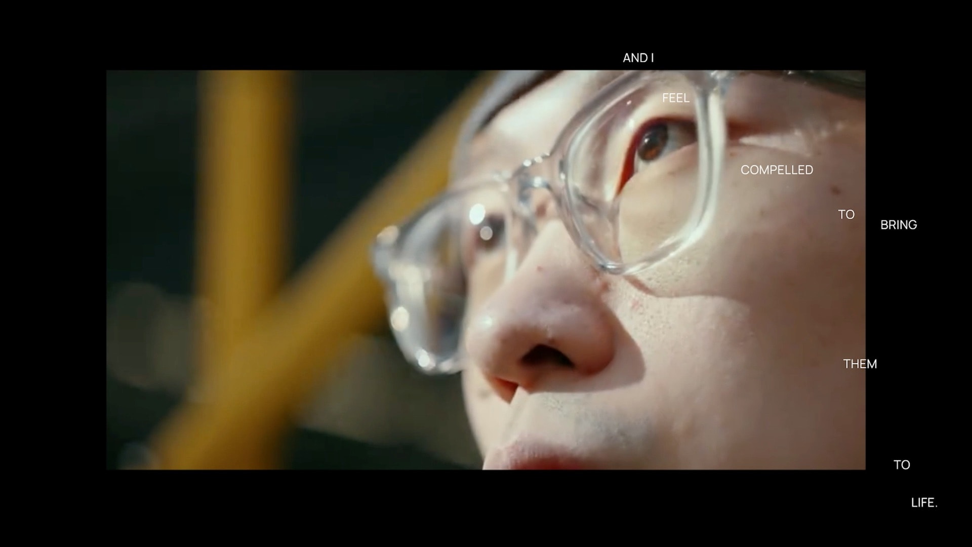Film still from the Design Hero documentary — close-up of Gao Han in glasses