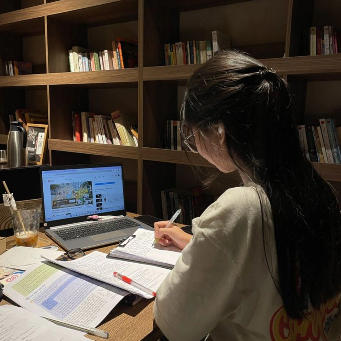 Hana Kim at her desk, working through printed notes